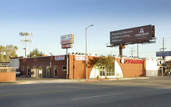 Rio Laundromat building at dusk with its sign lit