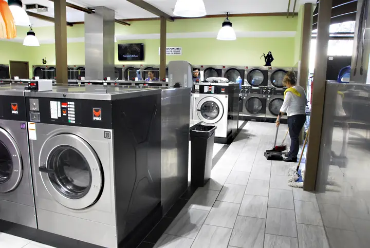 Staff keeping the laundromat floor clean
