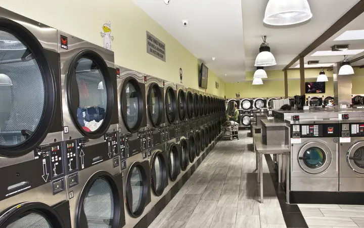 Long rows of new washers and stacked dryers