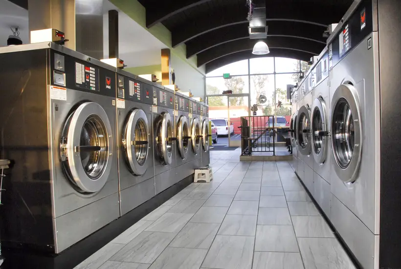Front-load washers with evening light through the windows